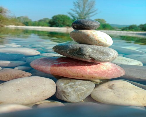 balanced stones near water for relaxation concept